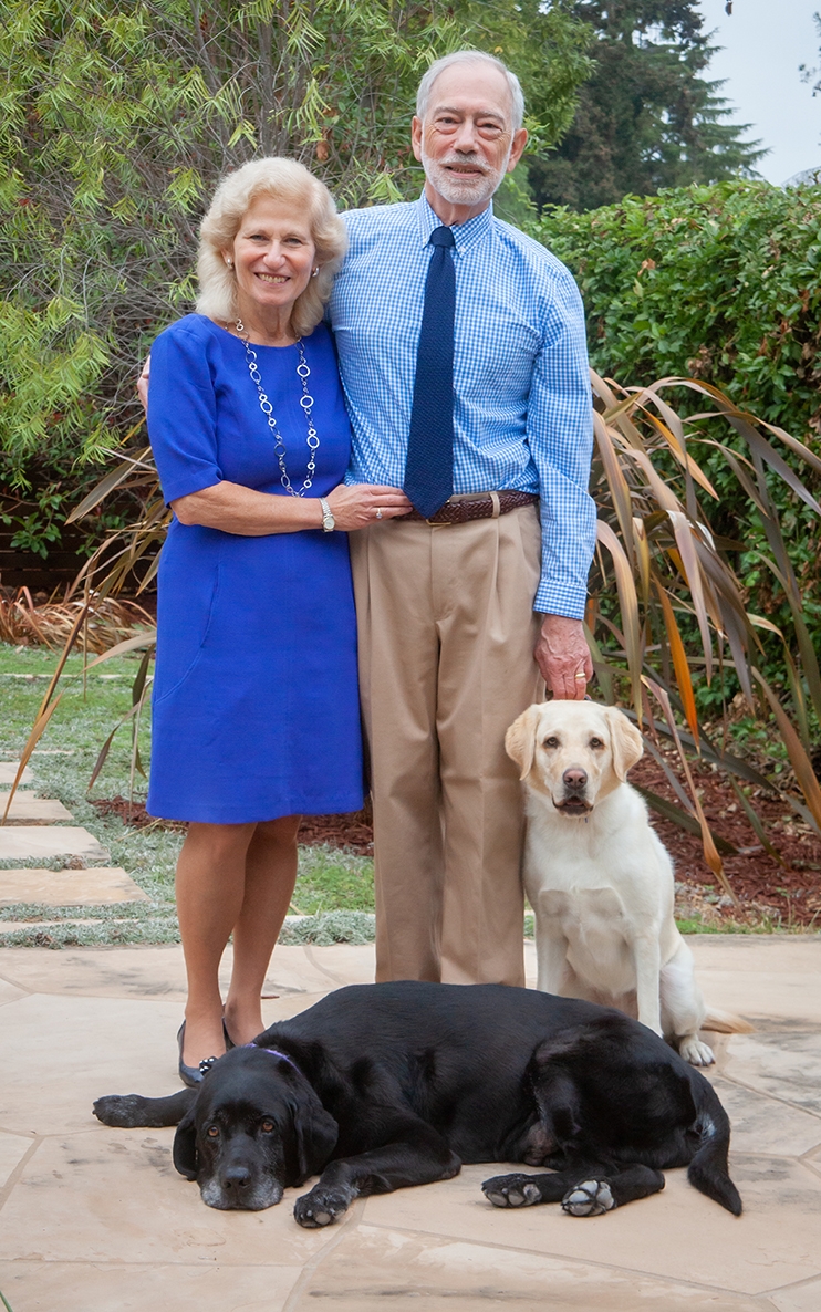 Donors Erika and John Ammirati pose in their yard with their carreer change dogs Fondy and Shiloh.