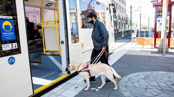 Chari Chauvin and her guide dog board a TriMet train