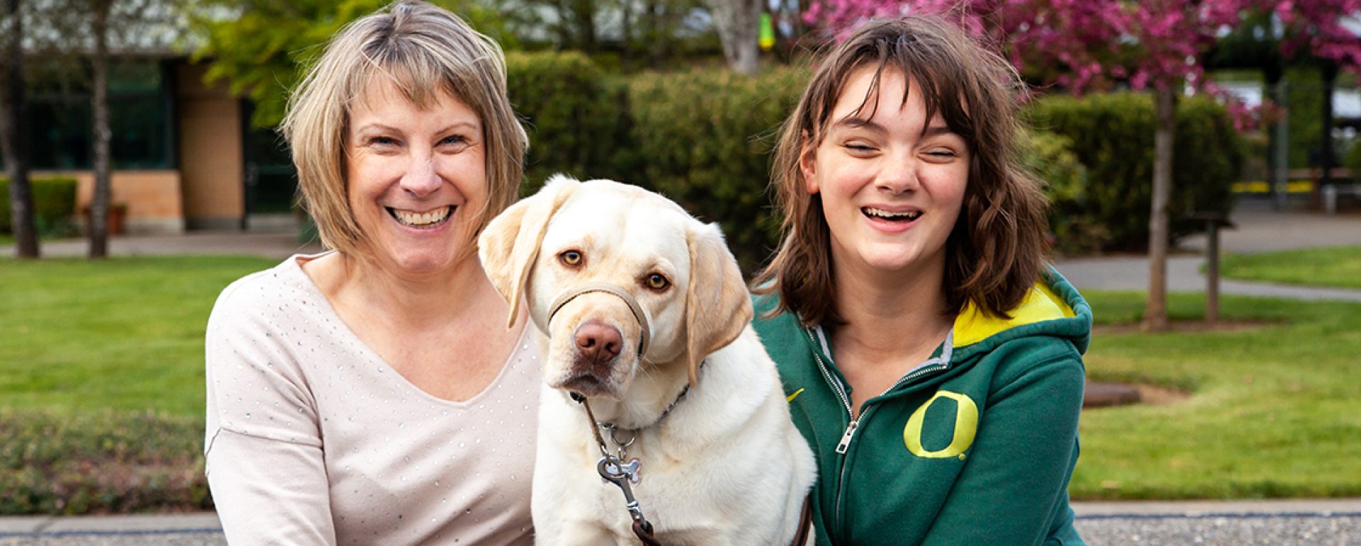 A mom with her daughter and a K9 Buddy dog.