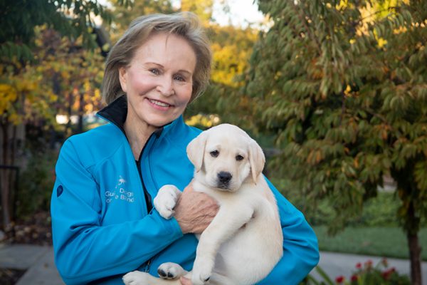GDB CEO Christine Benninger holds a yellow Lab puppy