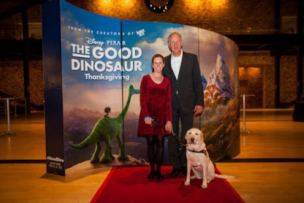 GDB alumna Jane Flower and her guide dog Anja at Pixar Headquarters with a Pixar executive.