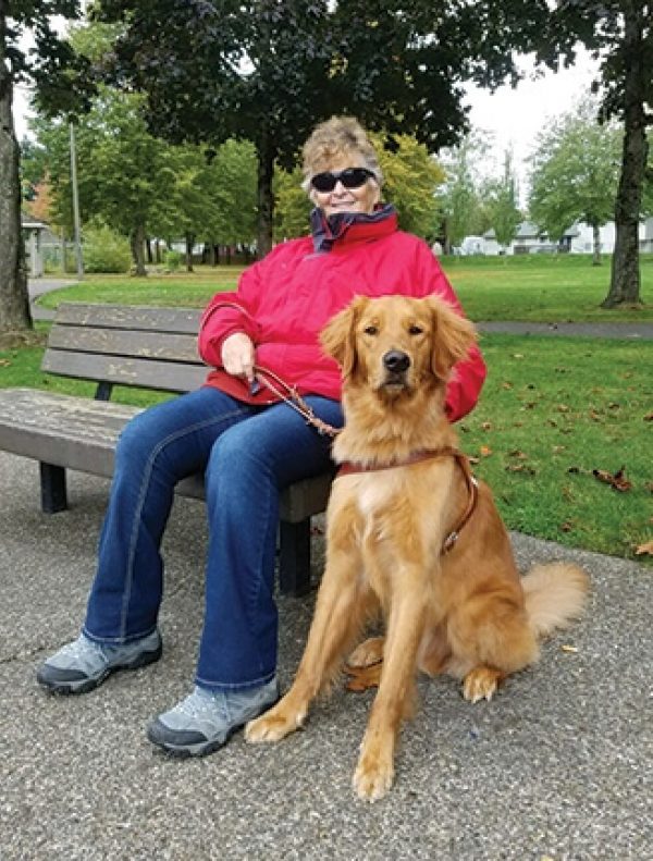 Sandra Shelby with her Golden Retriever guide dog, Neptune.